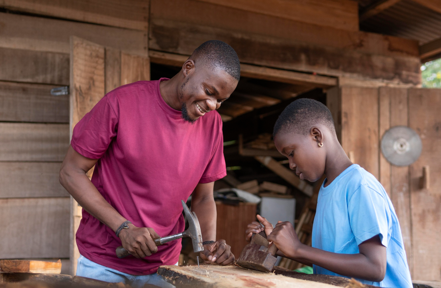 A craftsman teaching a young girl carpentry skills