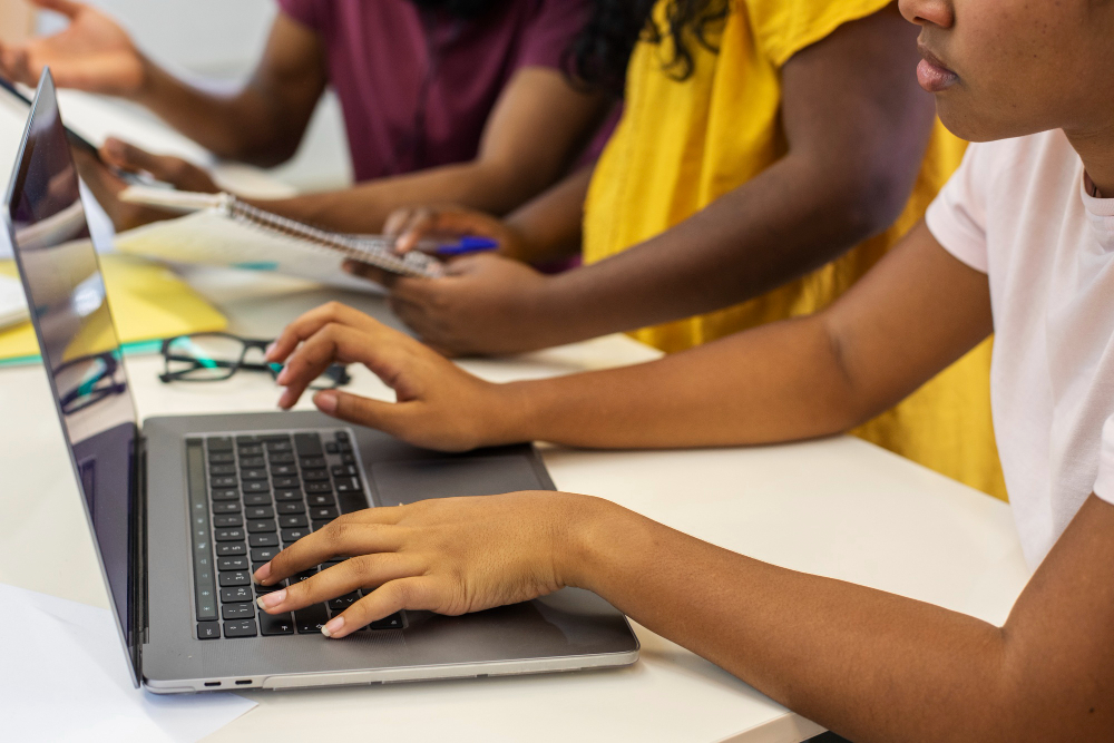 Students learning digital skills on laptops